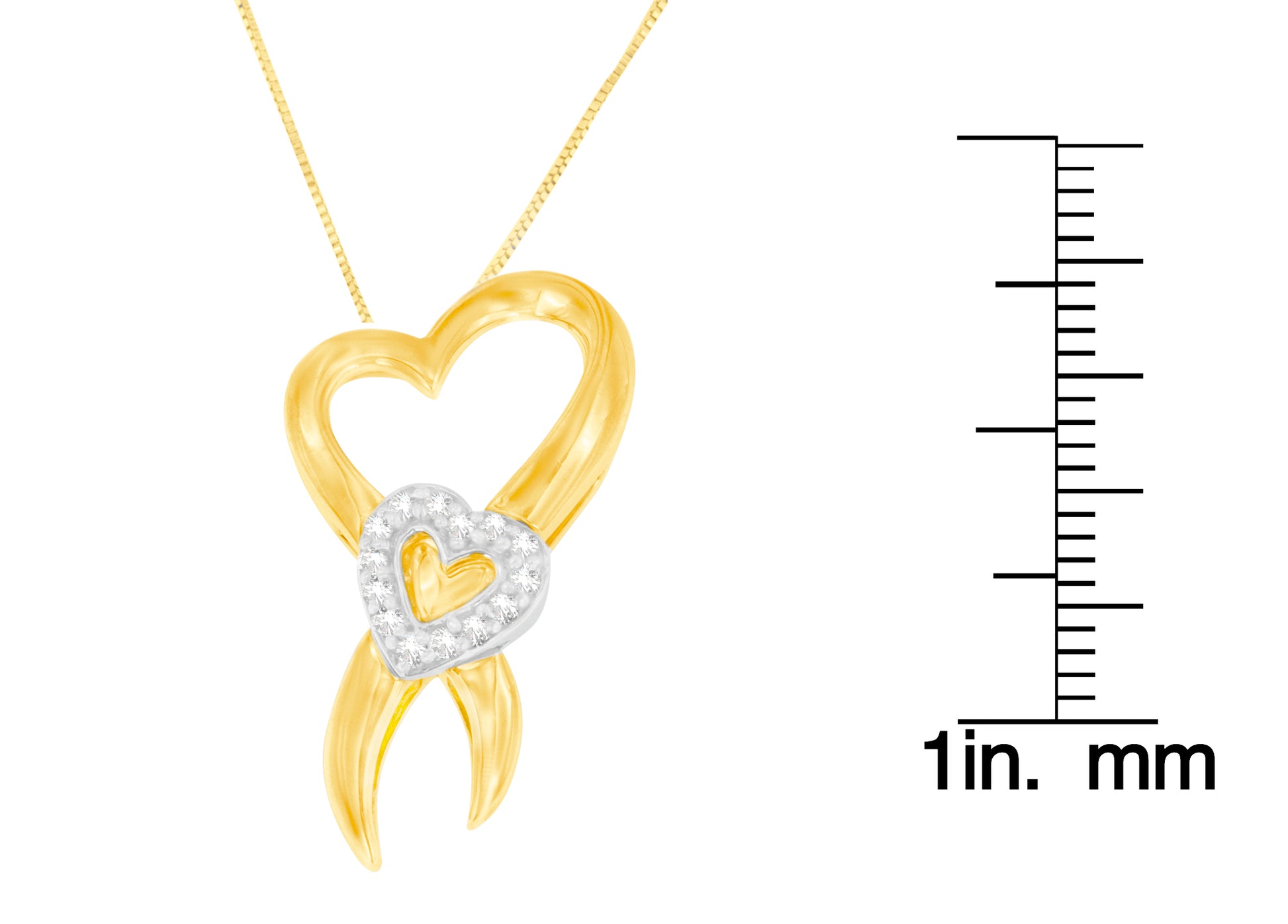 Close-up front view of a yellow and white metal heart-shaped necklace pendant with small white gemstones in prong settings on the white metal heart, shown with a ruler for size reference.