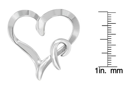 Close-up front angle of a white metal heart-shaped necklace pendant next to a ruler for size reference.