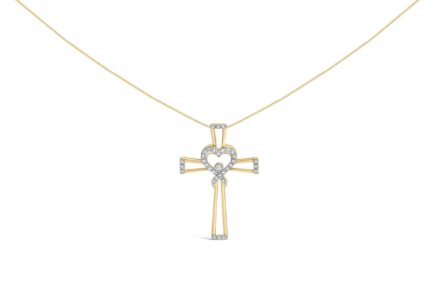 Yellow metal cross-shaped necklace pendant with a heart and ribbon design adorned with white round prong-set gemstones, front view.