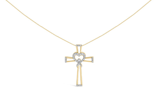 Yellow metal cross-shaped necklace pendant with a heart and ribbon design adorned with white round prong-set gemstones, front view.