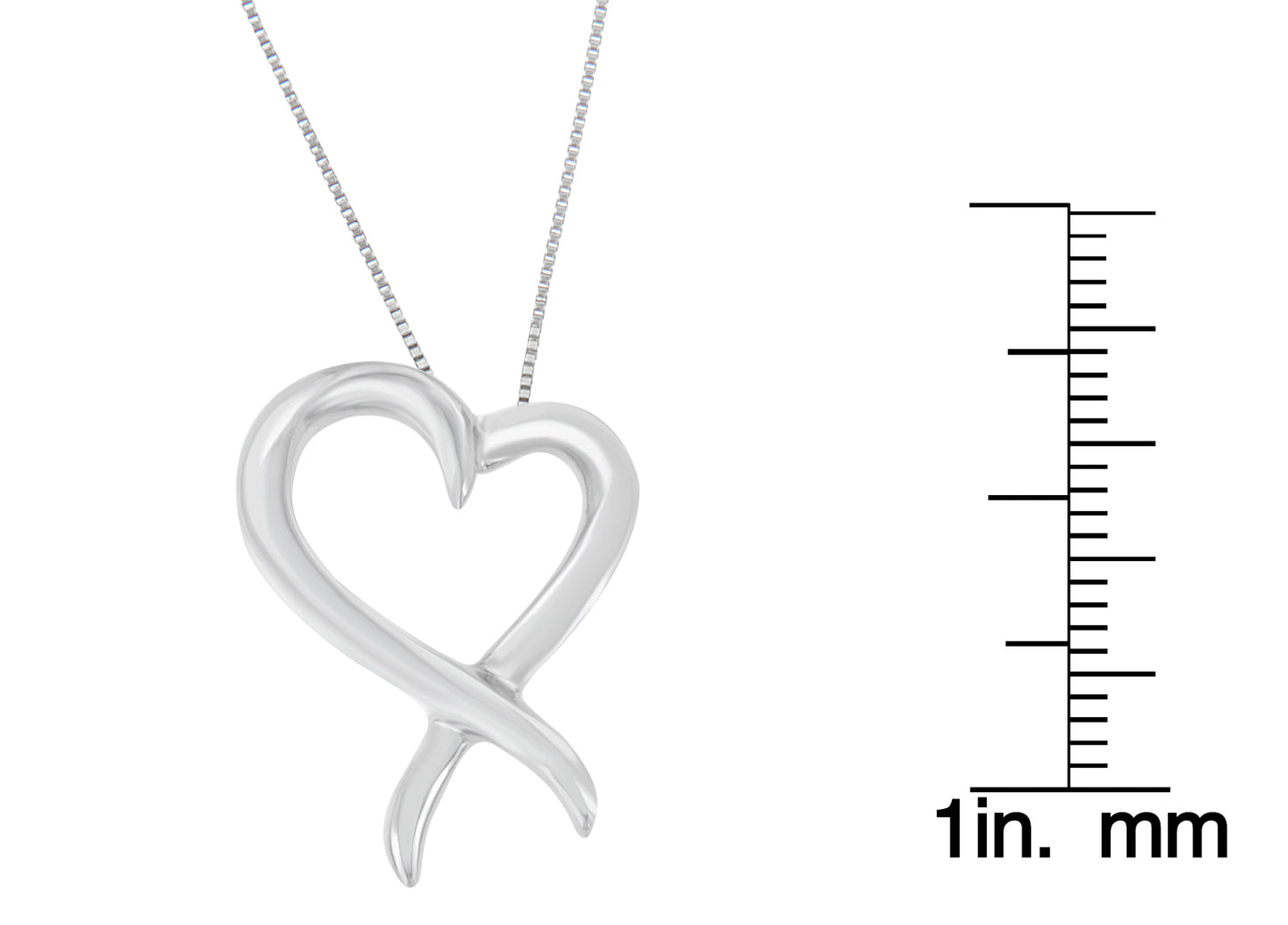Front view of a white metal heart-shaped necklace pendant next to a ruler for size reference.