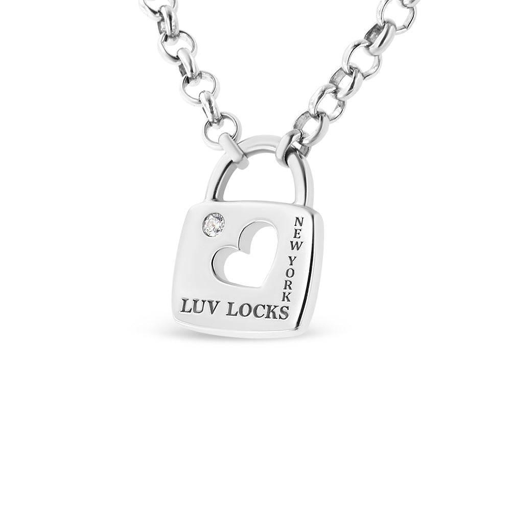 Close-up front angle of a white metal necklace with a padlock-shaped pendant featuring a heart cutout, one round white gemstone in a bezel setting, and engraved text 'LUV LOCKS' and 'NEW YORK'.