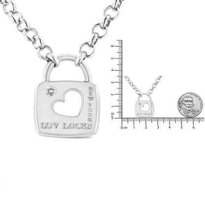 Front angle of a white metal necklace with a pendant shaped like a padlock featuring a cutout heart, a round white gemstone in bezel setting, and engraved text reading 'LUV LOCKS' and 'NEW YORK,' shown with a ruler and coin for size reference.