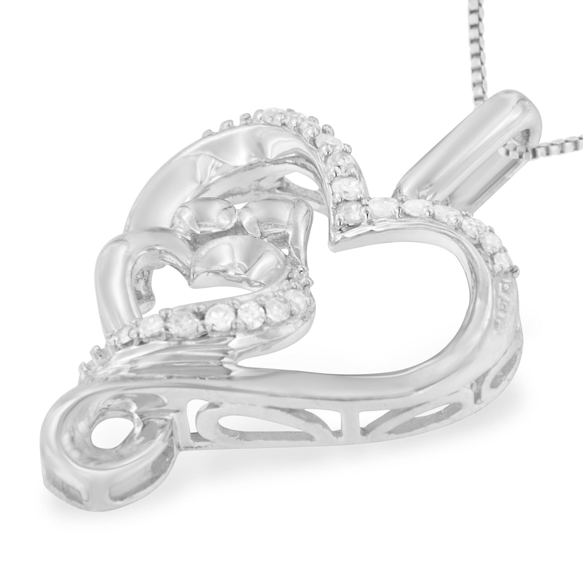 Close-up angled view of a white metal heart-shaped necklace pendant featuring multiple round white gemstones in prong settings along the heart's outline and inner decorative swirl.