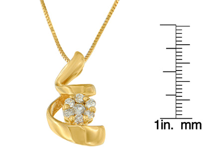 Yellow metal necklace pendant with seven round white gemstones in prong settings, shown in a close-up front angle with a ruler for size reference.