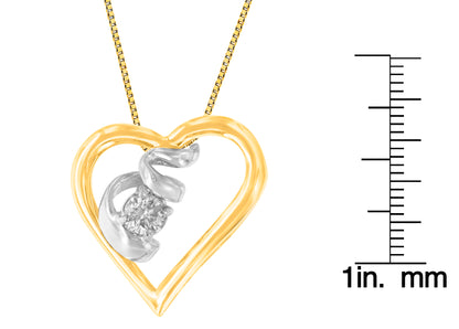 Close-up front angle of a necklace featuring an open heart-shaped pendant in yellow and white metal with a single round white gemstone in prong setting, shown next to a ruler for size reference.