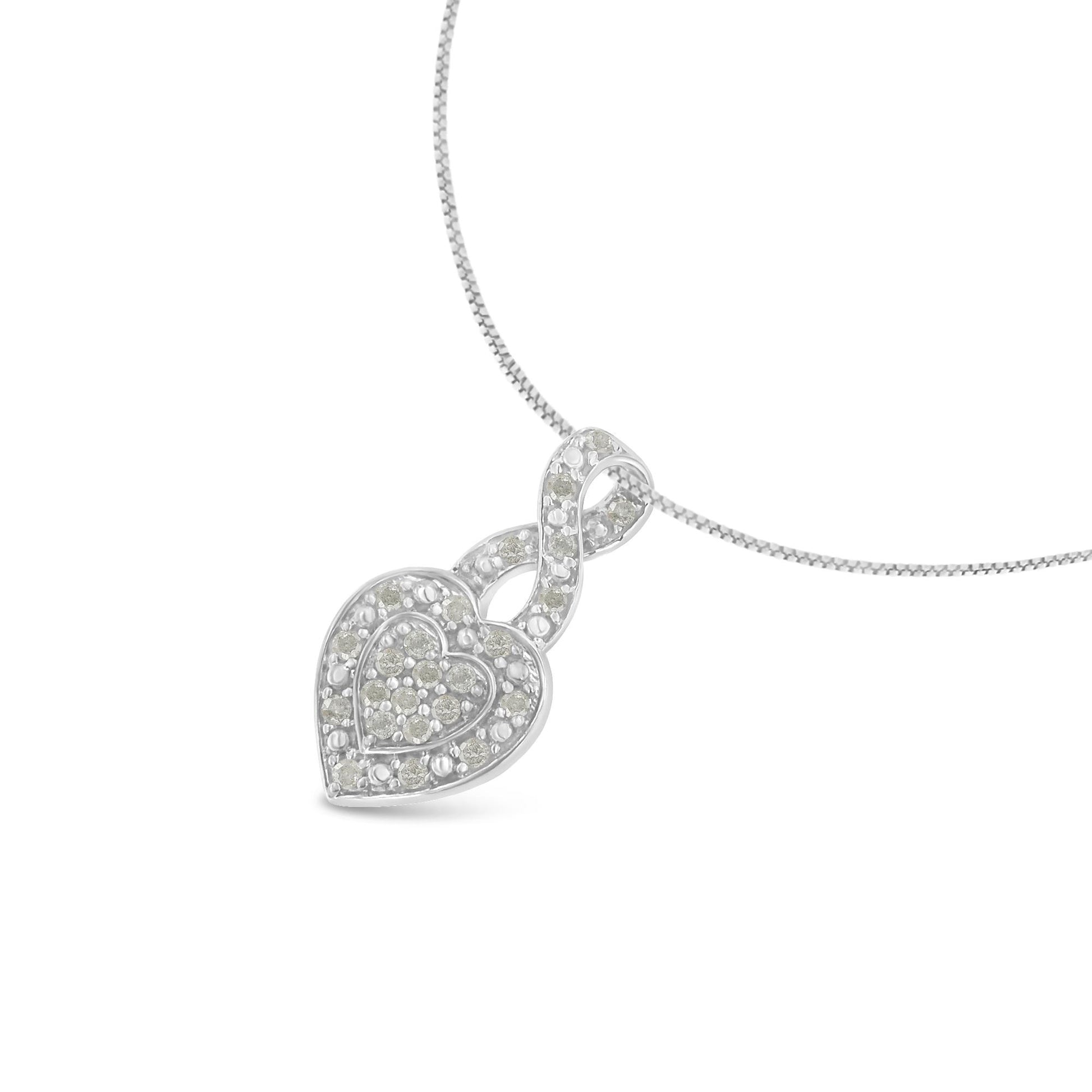 Close-up front angle of a white metal necklace with a heart-shaped pendant featuring round white gemstones in a pave setting.