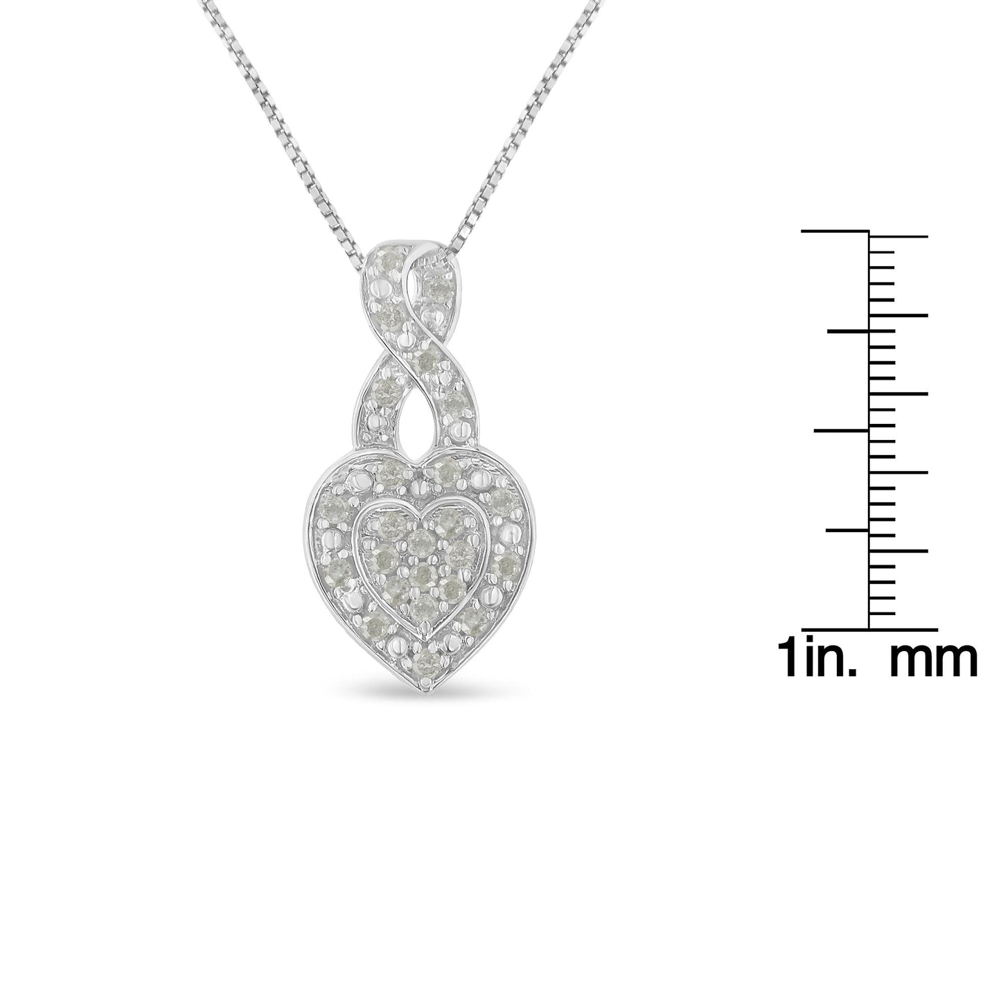 Front view of white metal heart-shaped necklace with pave-set round white gemstones, shown beside a ruler for size reference.