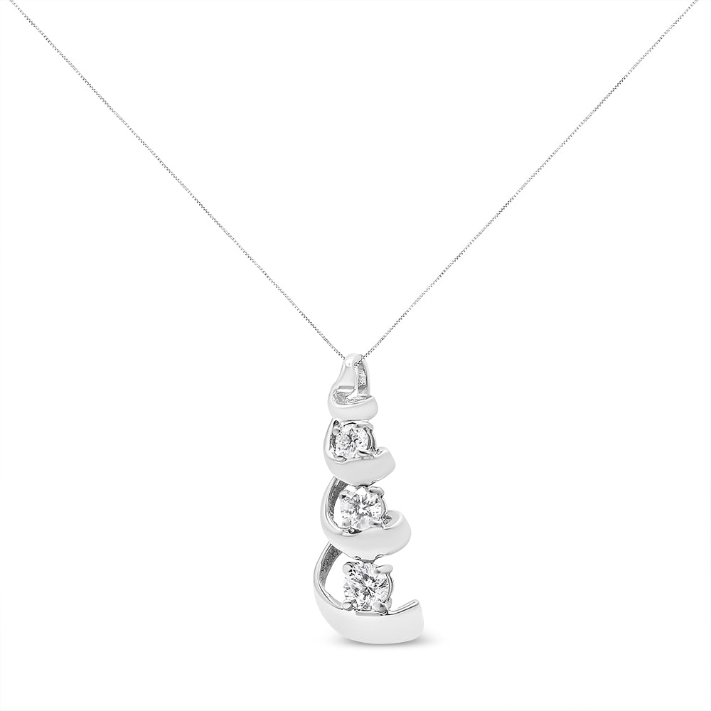 Front angle view of a white metal necklace with a pendant featuring three round white gemstones in prong settings.