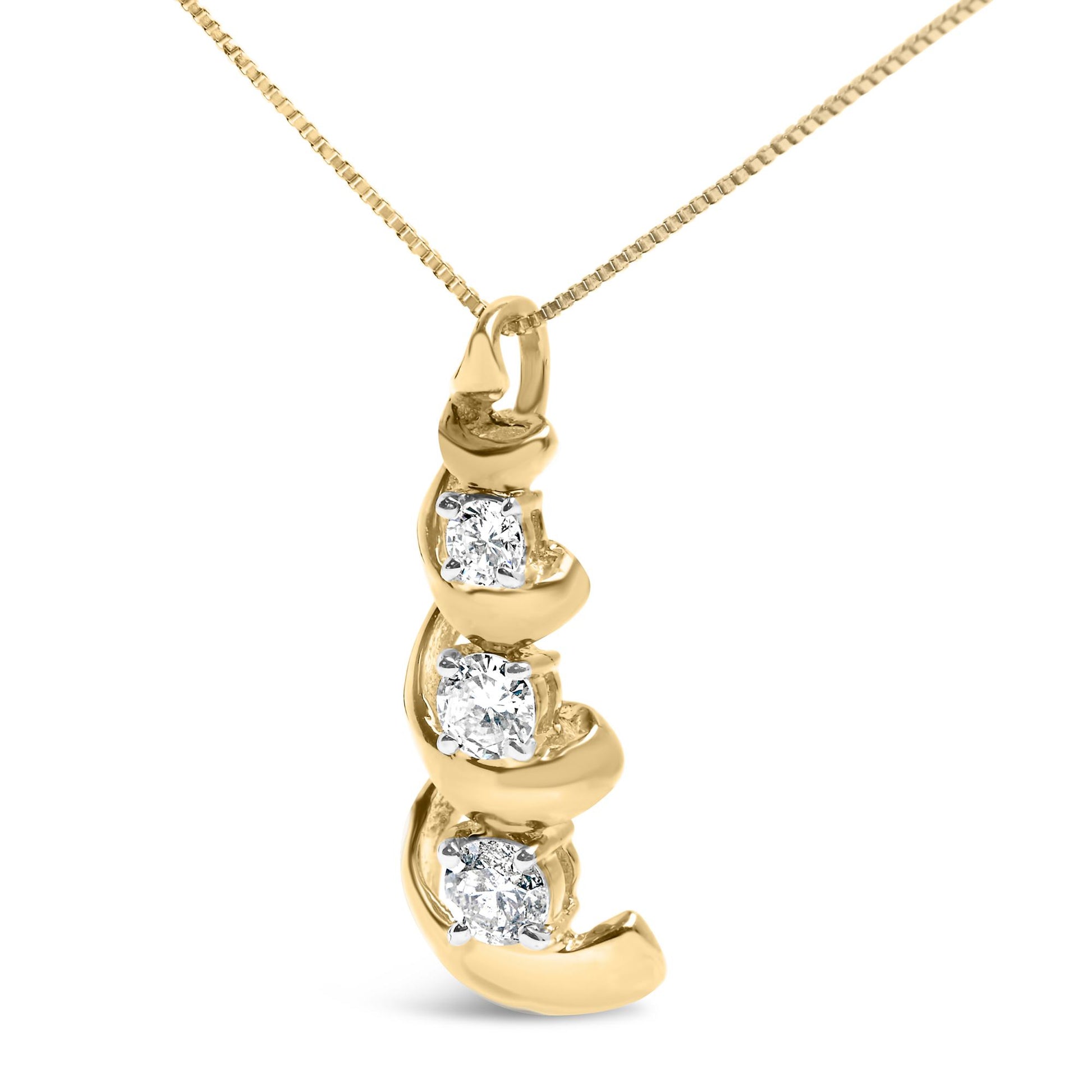 Close-up front angle of a yellow metal necklace pendant featuring three round white gemstones set in prongs along a curved design.