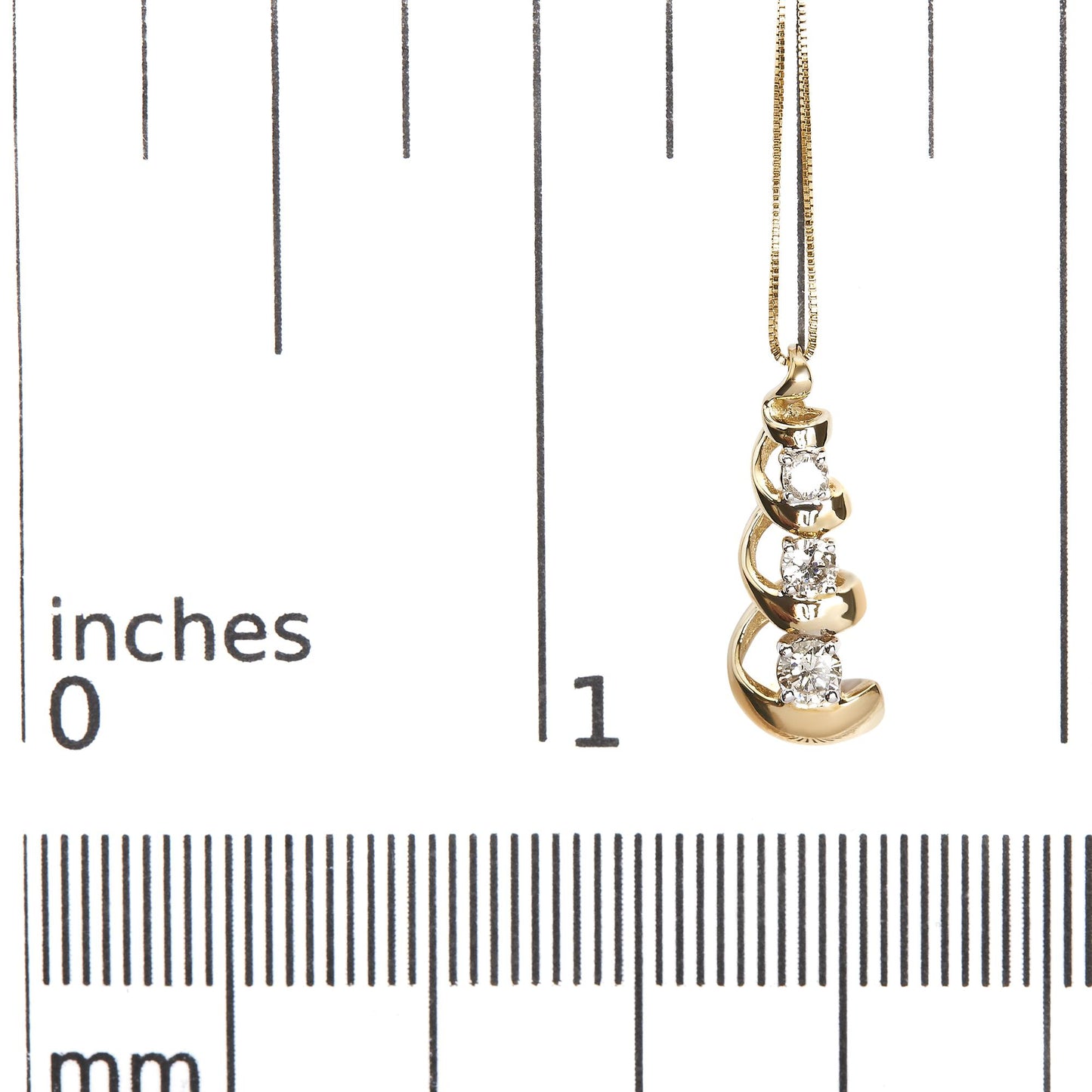 Yellow metal necklace pendant with three white round gemstones in prong settings arranged vertically within a curved design, shown hanging on a scale with a front angle.