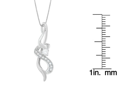 White metal necklace pendant with a twisted design featuring round white gemstones in prong settings, photographed straight on with a size ruler to the right.
