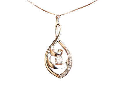 Close-up front angle of a white metal necklace with a pendant featuring one central round white gemstone and additional smaller round white gemstones along one side of the pendant's swirl design.
