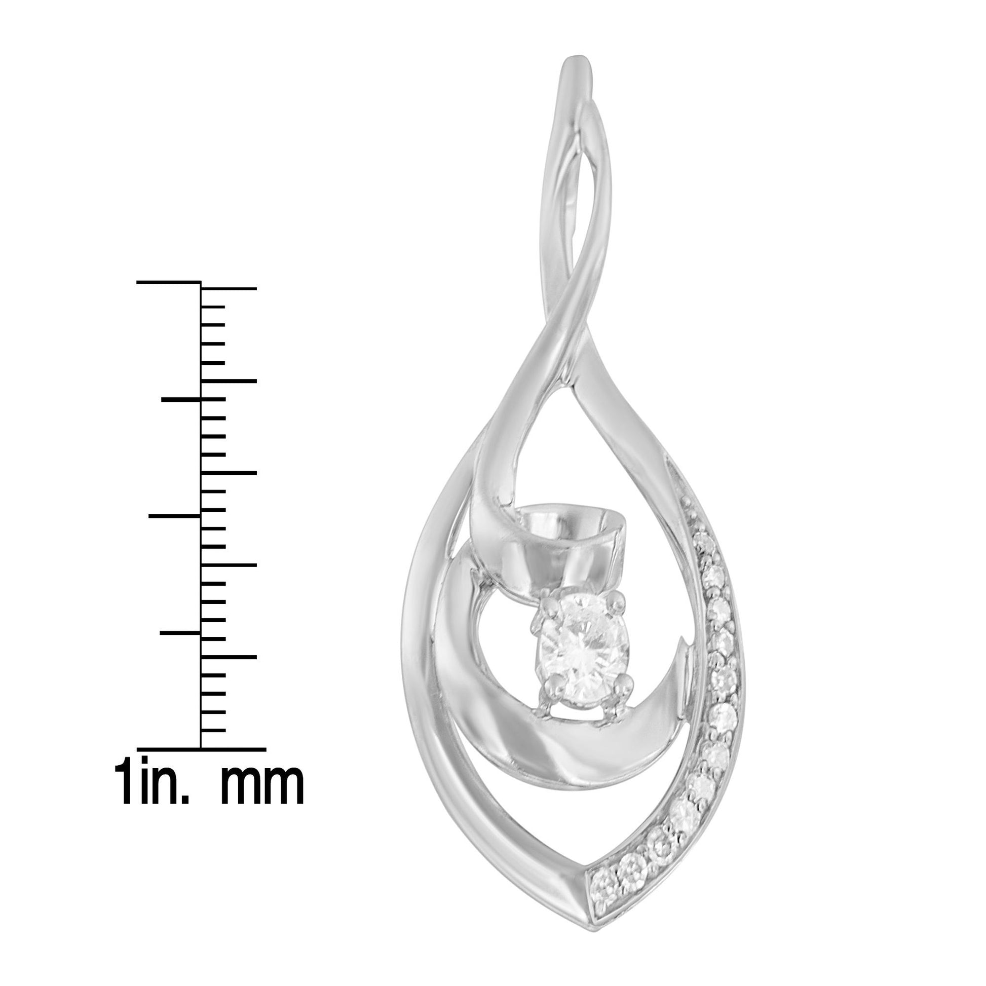 White metal twisted teardrop-shaped necklace pendant with one central round white gemstone and smaller round white gemstones along one side, shown from front angle and placed next to a ruler for size reference.