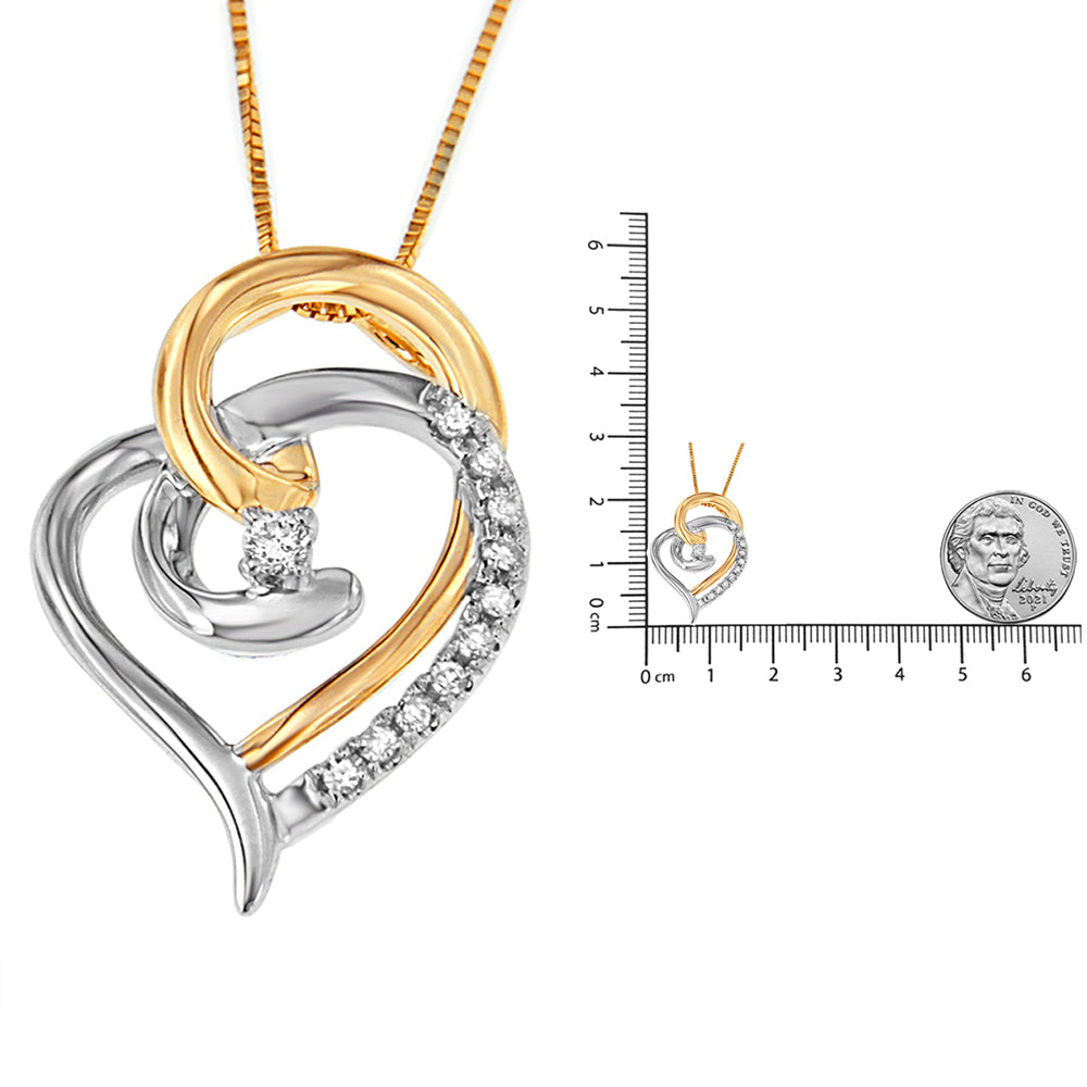 Two-toned heart-shaped necklace pendant with round white gemstones in prong settings, photographed front-facing next to a ruler and coin for size reference.