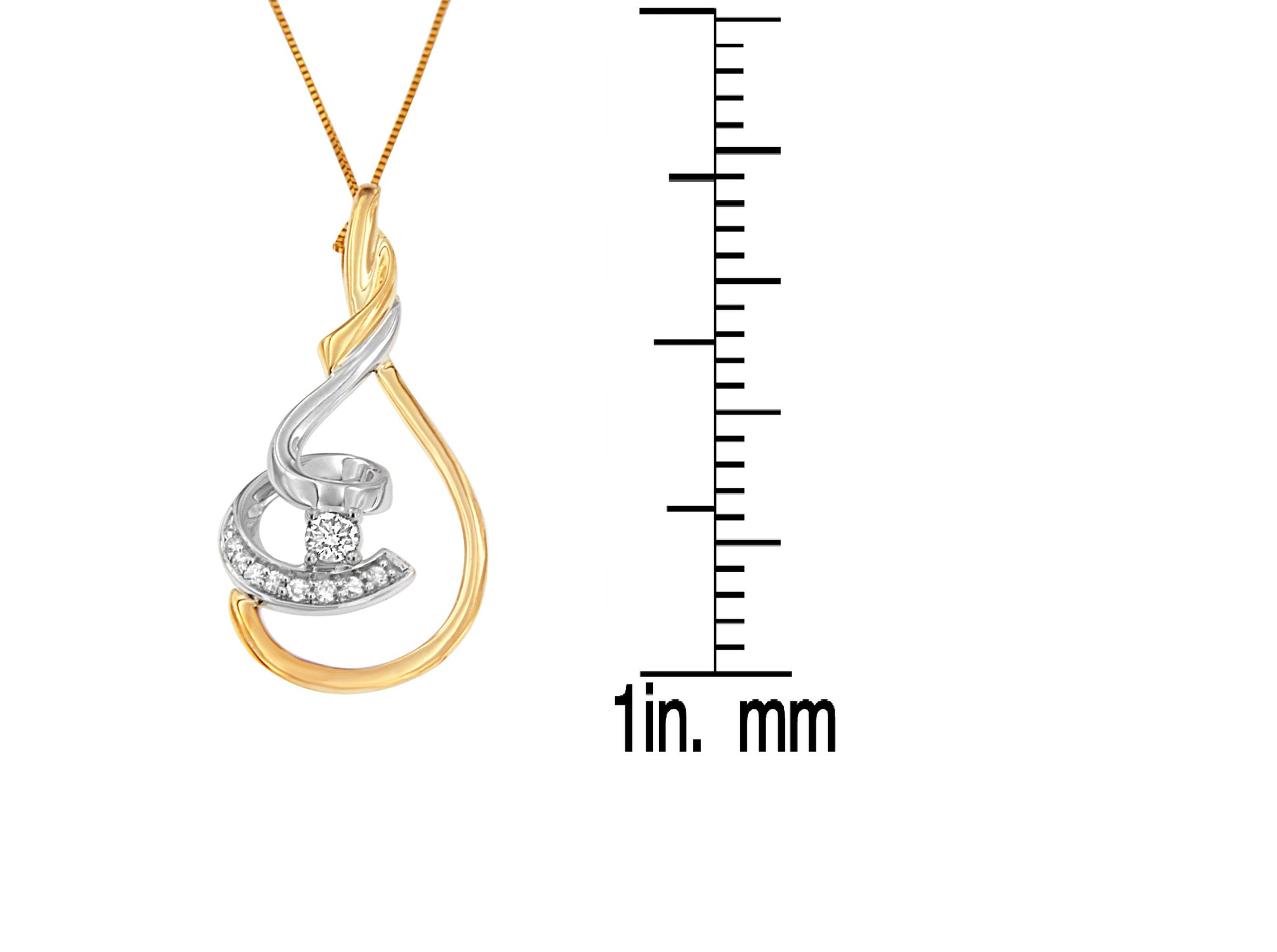 Two-toned necklace pendant with curved design and round white gemstones in prong settings, photographed in a front view with a ruler for size reference.