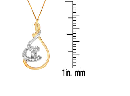 Two-toned necklace pendant with curved design and round white gemstones in prong settings, photographed in a front view with a ruler for size reference.