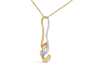 Two-toned necklace pendant with an abstract curved design, featuring one larger and several smaller round white gemstones in prong settings, shown in a front-angle close-up.