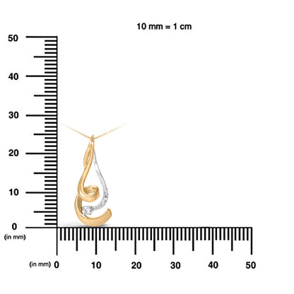 Two-toned necklace pendant with a swirl design featuring white round gemstones, displayed on a ruler for size reference, front view.