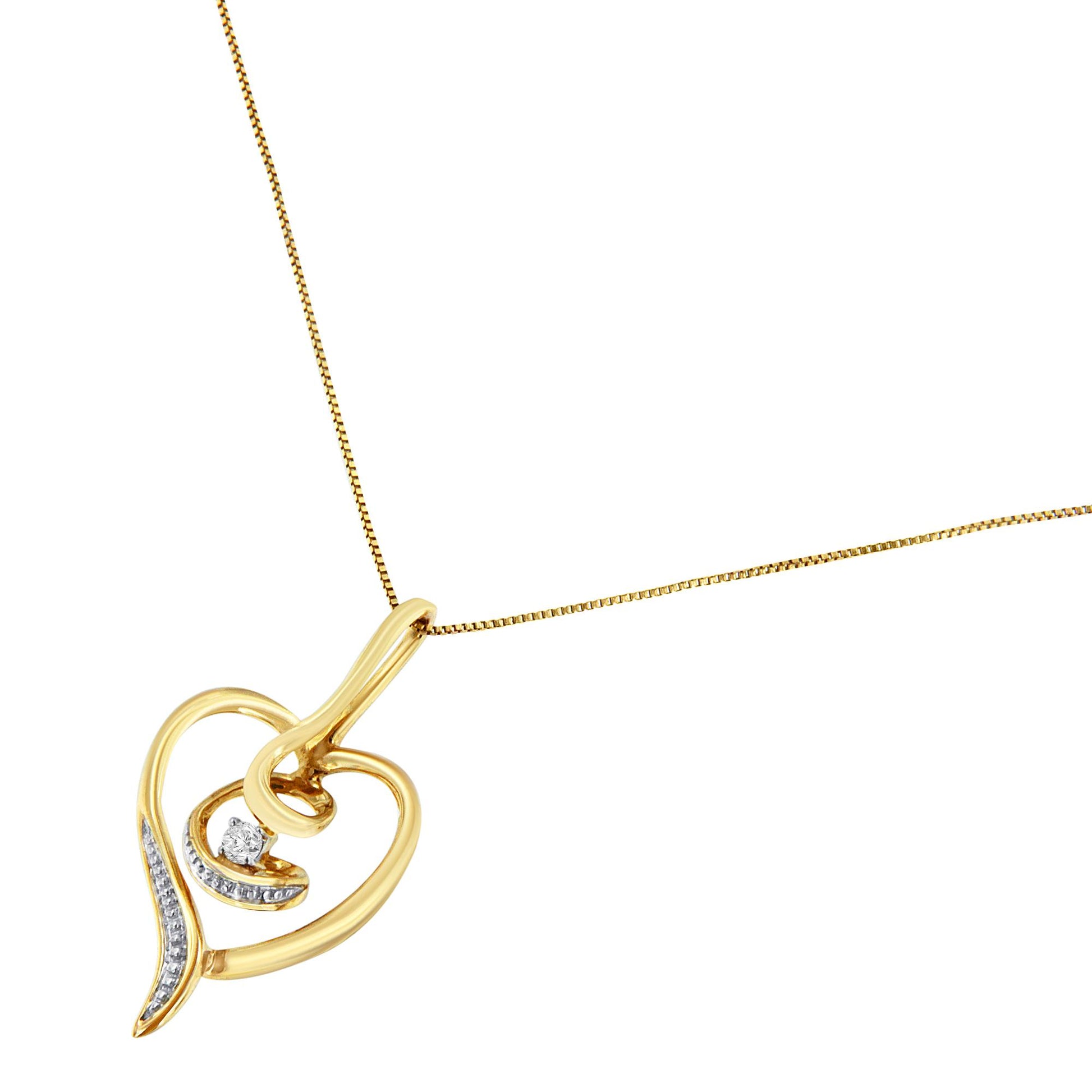 Yellow metal heart-shaped necklace with a small round white gemstone in prong setting inside, shown at an angled close-up.