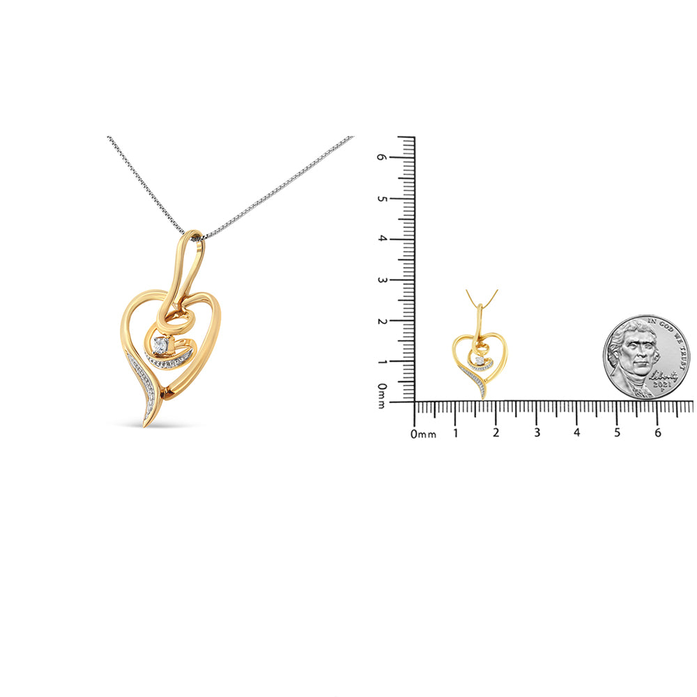 Yellow heart-shaped necklace pendant with a single prong-set white gemstone and smaller white gemstones along one side, shown in a front view and on a ruler for size reference.