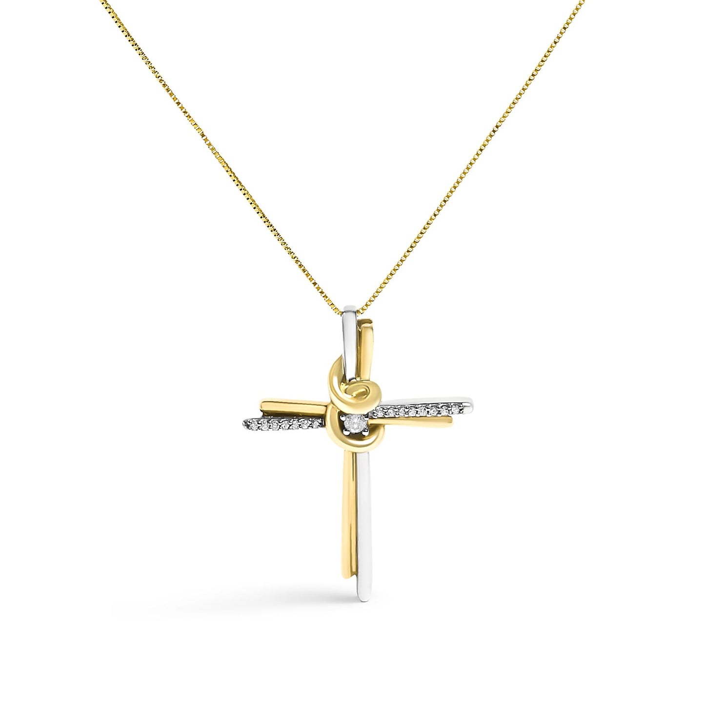 Front-facing shot of a two-toned cross necklace pendant with a knot detail at the center, adorned with one round white gemstone in the middle and a row of small round white gemstones along the horizontal bar, hanging from a chain.