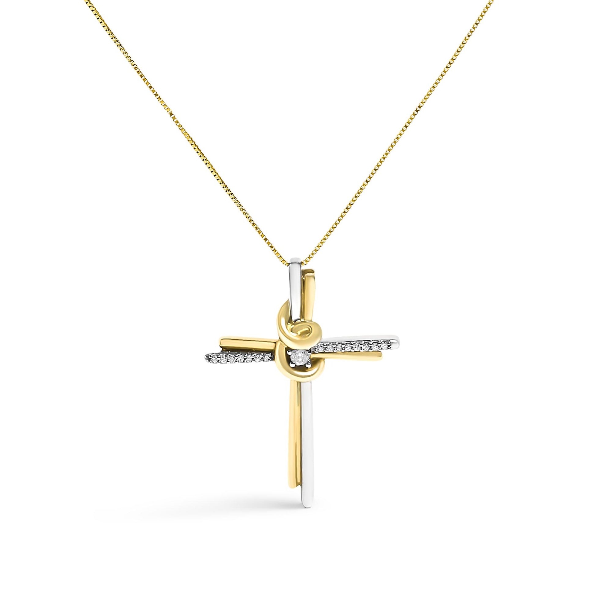 Front-facing shot of a two-toned cross necklace pendant with a knot detail at the center, adorned with one round white gemstone in the middle and a row of small round white gemstones along the horizontal bar, hanging from a chain.