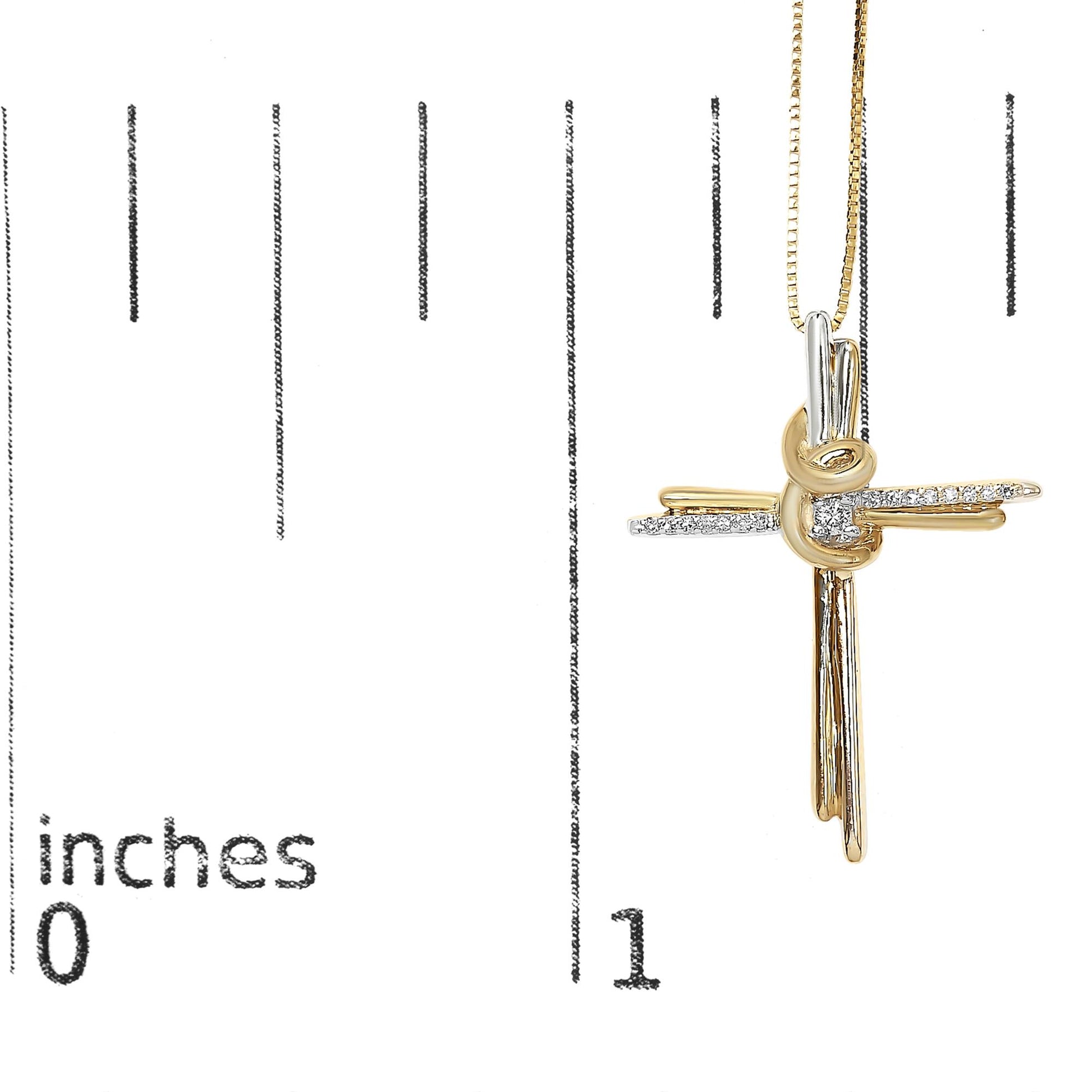Two-toned necklace with a cross-shaped pendant featuring one central round white gemstone and a cluster of smaller round white gemstones on horizontal bars, photographed straight on, hanging on a ruler for size reference.