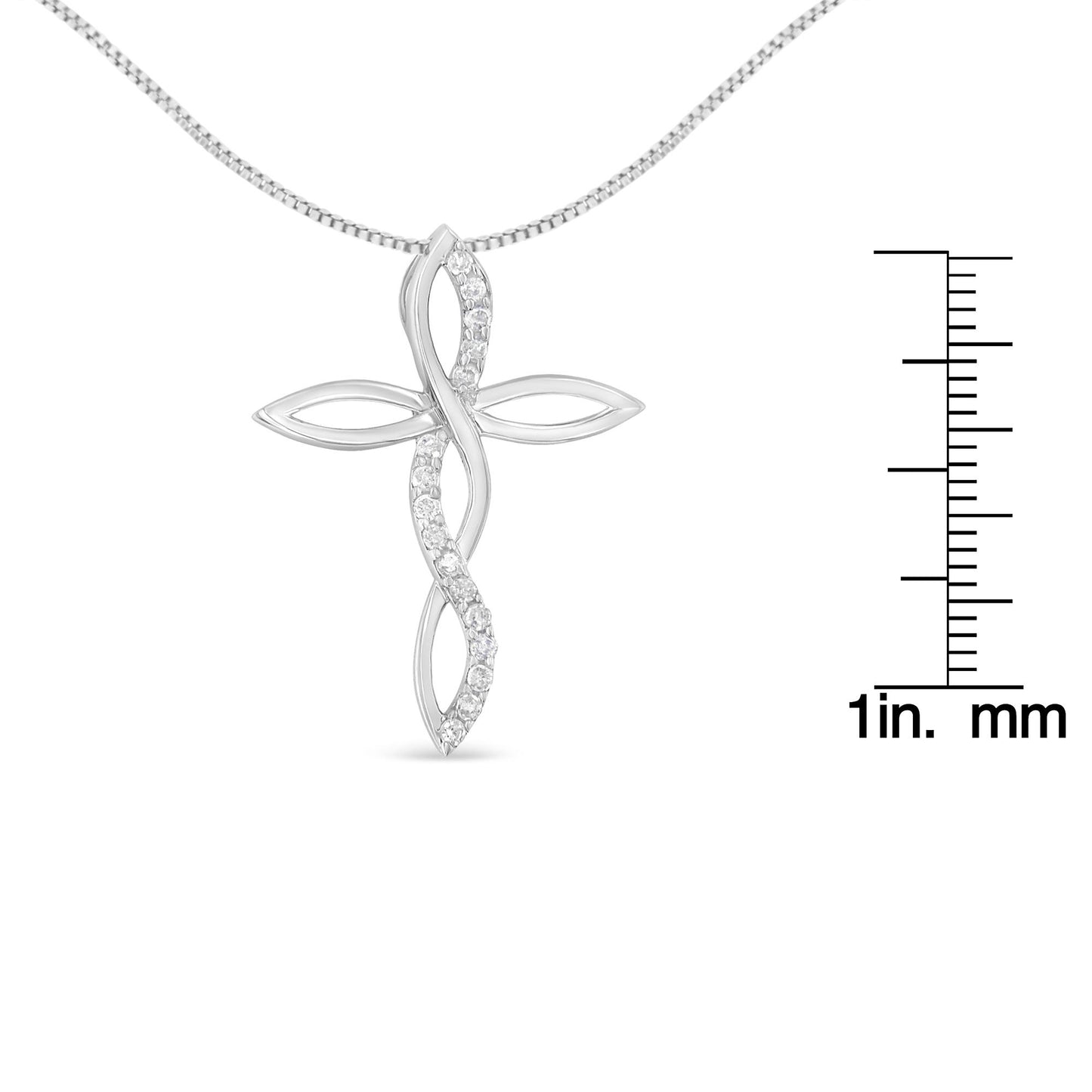 Front view of a white metal cross-shaped necklace pendant with a twisted design featuring round white gemstones in prong settings, shown with a ruler for size reference.