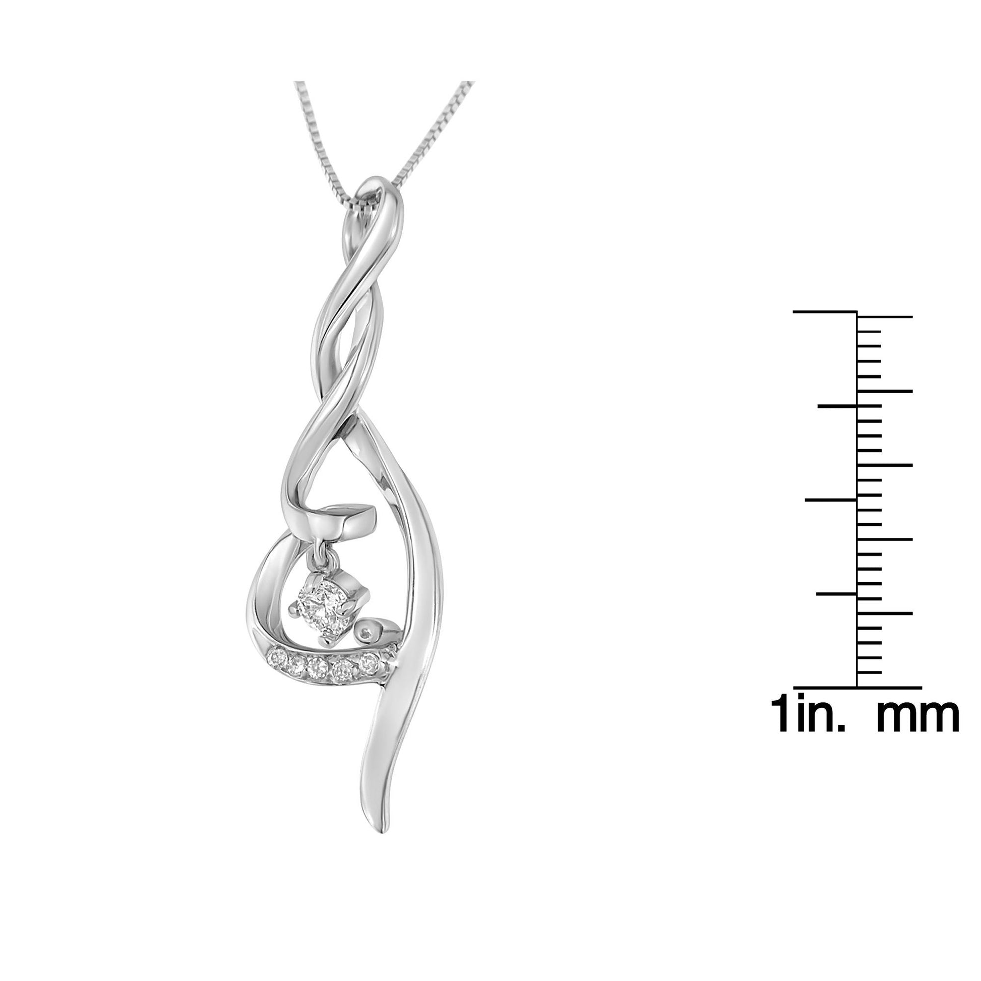 Close-up front view of a white metal necklace pendant with a twisted design, featuring multiple round white gemstones in prong settings, shown with a ruler for size reference.