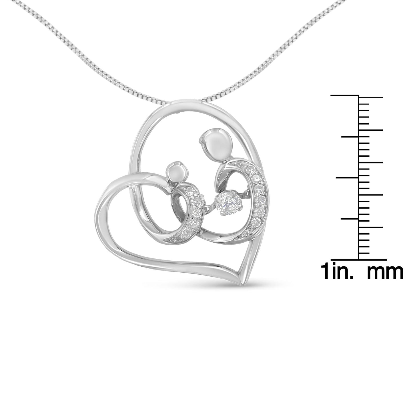 Front angle view of a white metal heart-shaped necklace pendant with two abstract figures inside, decorated with multiple white round gemstones in prong settings, shown with a ruler for size reference.