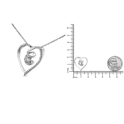 White heart-shaped necklace with curved design and white gemstones, shown at an angle and next to a ruler and coin for size reference.