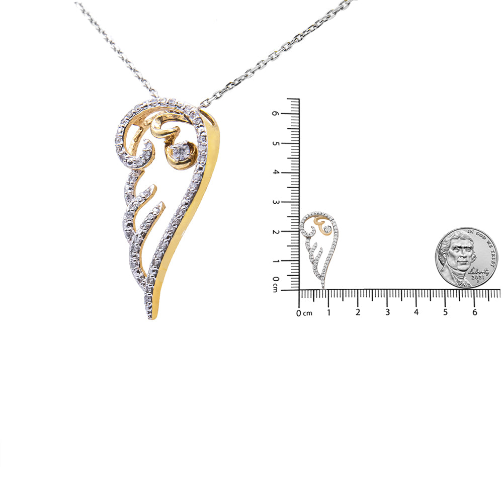 Yellow metal necklace pendant with a swirl design, accented with round white gemstones in prong settings, shown hanging from a chain with pendant also placed on a ruler and beside a coin for size reference, front angle.