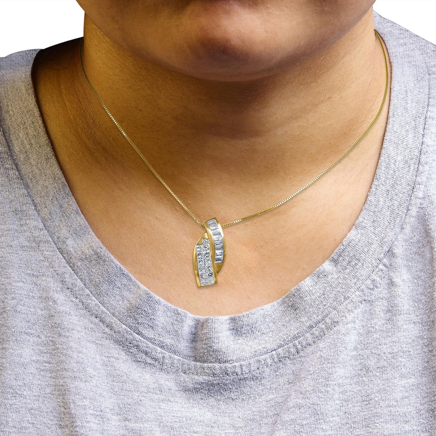 Necklace with a yellow metal chain and a modern pendant featuring two overlapping curved sections, one set with white baguette-shaped gemstones in a channel setting and the other with white princess-shaped gemstones in an invisible setting, worn on a model, close-up front view.
