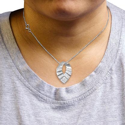 Close-up front view of a white metal necklace with an abstract loop-shaped pendant featuring channel-set baguette-shaped white gemstones and invisible-set princess-shaped white gemstones, shown worn on a model.
