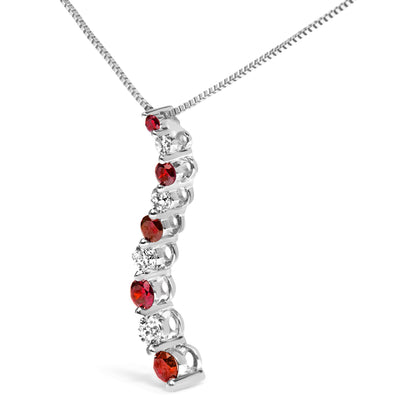 Close-up angled view of a white metal necklace pendant featuring alternating red and white round gemstones in a shared prong setting.