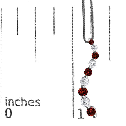 Close-up front view of a white metal necklace pendant with alternating round red and white gemstones in a shared prong setting, displayed on a ruler for size reference.