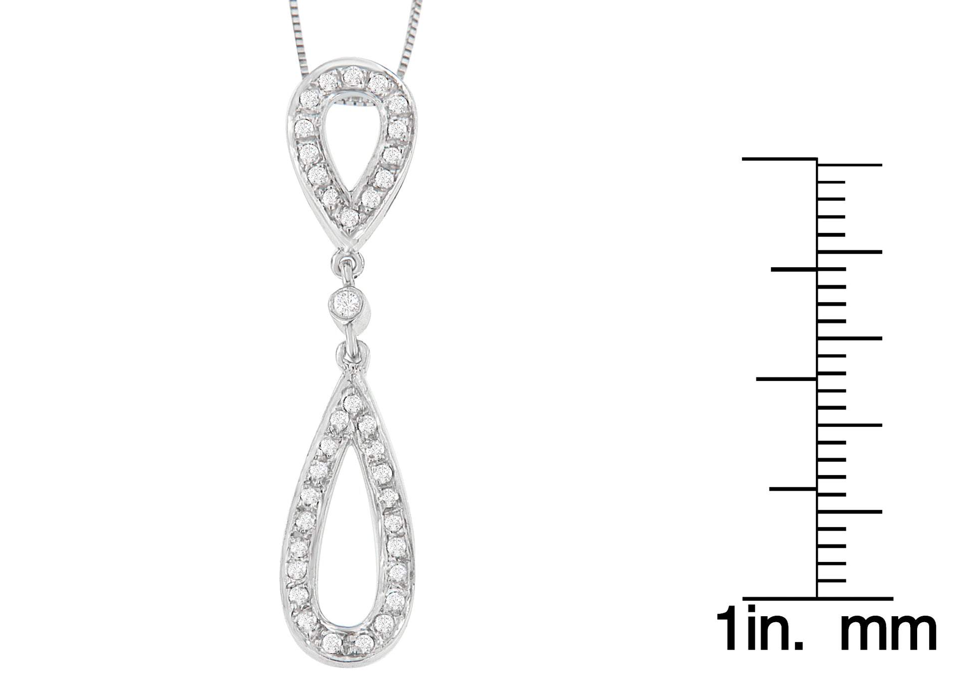 Close-up front view of a white necklace with two connected teardrop-shaped pendants, each outlined with round white gemstones in prong settings, shown next to a ruler for size reference.