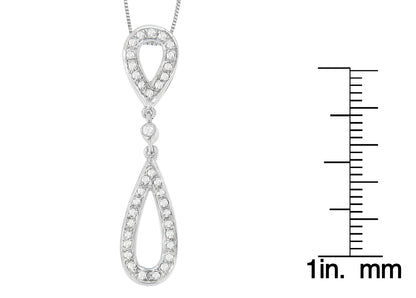 Close-up front view of a white necklace with two connected teardrop-shaped pendants, each outlined with round white gemstones in prong settings, shown next to a ruler for size reference.