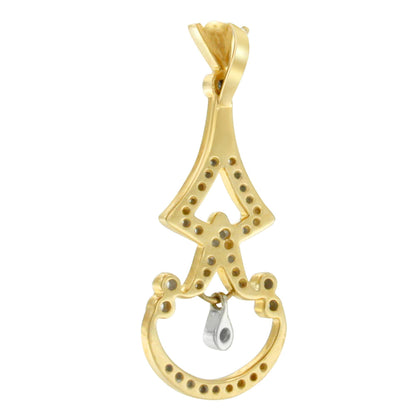 Close-up front angle of a yellow metal necklace pendant with round white gemstones in pave settings.