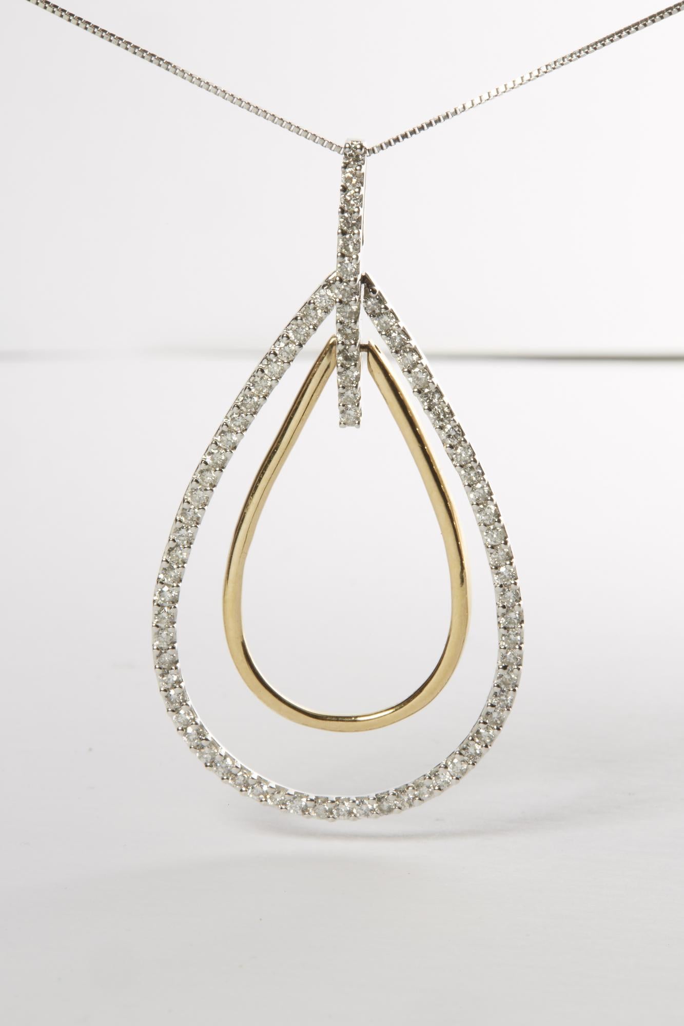 Front-facing close-up of a two-toned necklace pendant featuring an outer teardrop shape adorned with small round white gemstones in prong setting, and a smaller smooth inner teardrop shape, suspended on a thin chain.