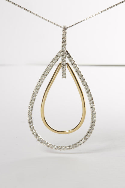 Front-facing close-up of a two-toned necklace pendant featuring an outer teardrop shape adorned with small round white gemstones in prong setting, and a smaller smooth inner teardrop shape, suspended on a thin chain.