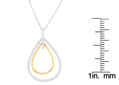 Two-toned teardrop-shaped necklace pendant with outer ring adorned with white gemstones in prong setting, inner plain metal teardrop shape, shown against white background with a scale on the right, front angle.