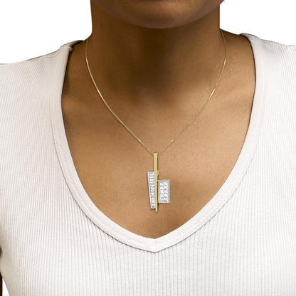 Necklace shown worn on a model from the front, featuring a vertical yellow metal bar pendant with two attached white metal rectangular sections set with channel-set white princess and baguette shape gemstones.