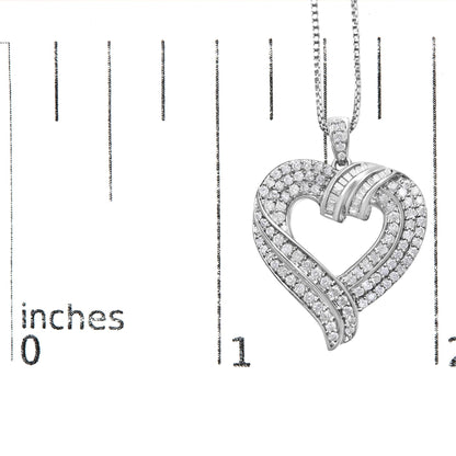 Close-up front view of a white metal heart-shaped necklace pendant with round white gemstones in prong settings and baguette white gemstones in channel settings, shown on a ruler for size reference.