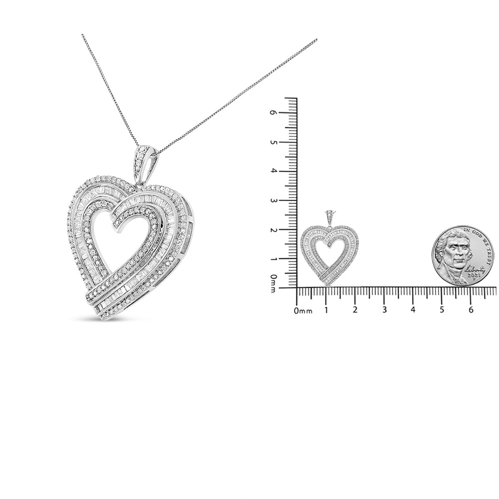 Close-up of a white metal heart-shaped necklace pendant with white round prong-set gemstones and baguette channel-set gemstones, photographed from the front. The pendant is shown next to a ruler and a coin for size reference.