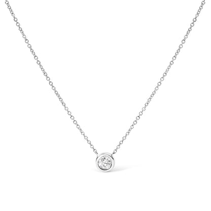 Front view of a white metal necklace with a round bezel-set white gemstone pendant on a fine chain against a white background.