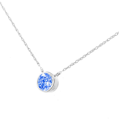 Close-up front angle of a white metal necklace with a round blue gemstone in a bezel setting.