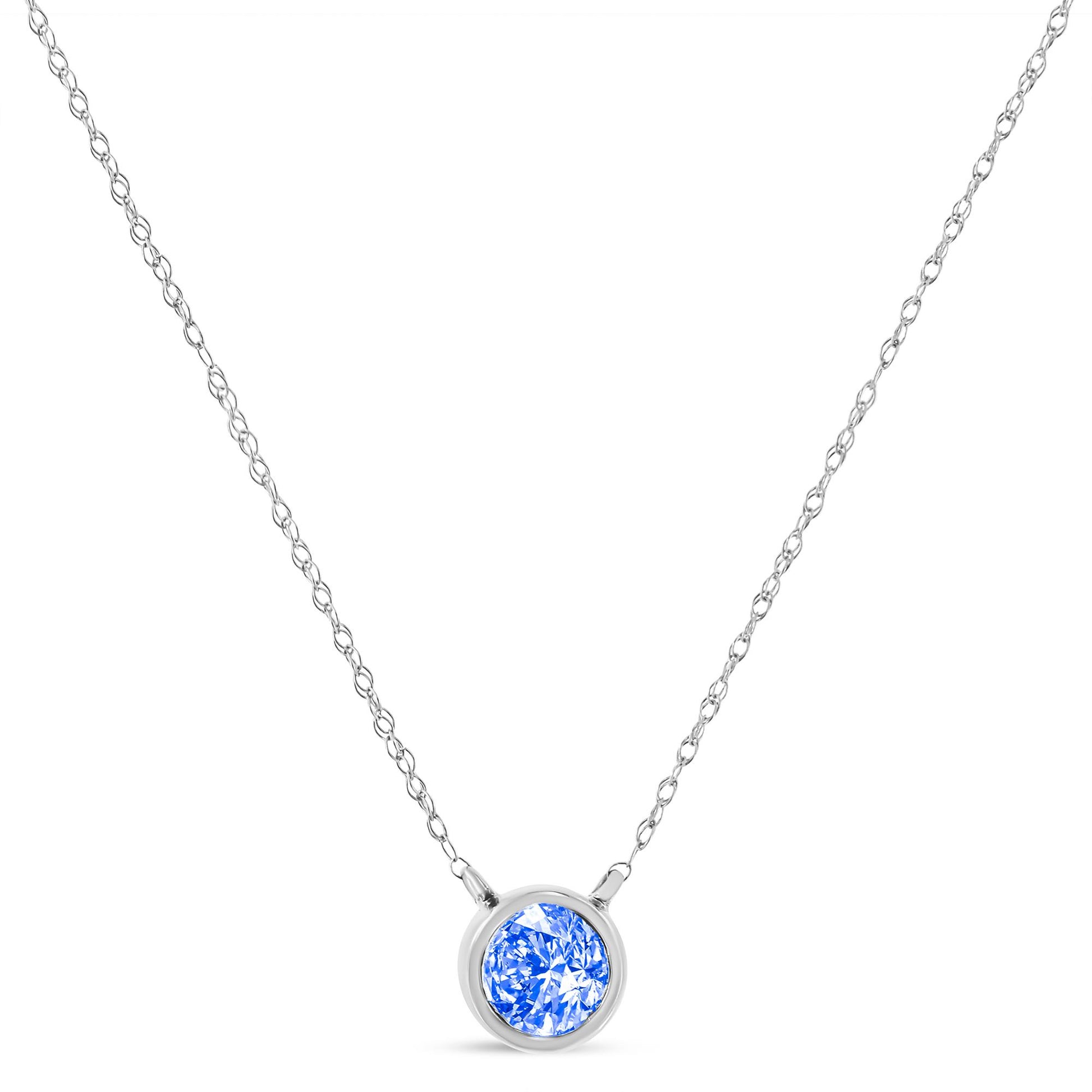 Front view of a white necklace with a single round blue gemstone in a bezel setting on a fine chain.