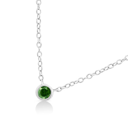 Close-up angled shot of a white metal necklace featuring a round green gemstone in a bezel setting.